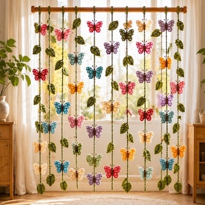 May include: A decorative hanging curtain featuring multiple vertical strands suspended from a wooden rod. Each strand is crocheted with green leaves and colorful butterflies in shades of red, blue, yellow, pink, purple, and orange, creating a vibrant display.
