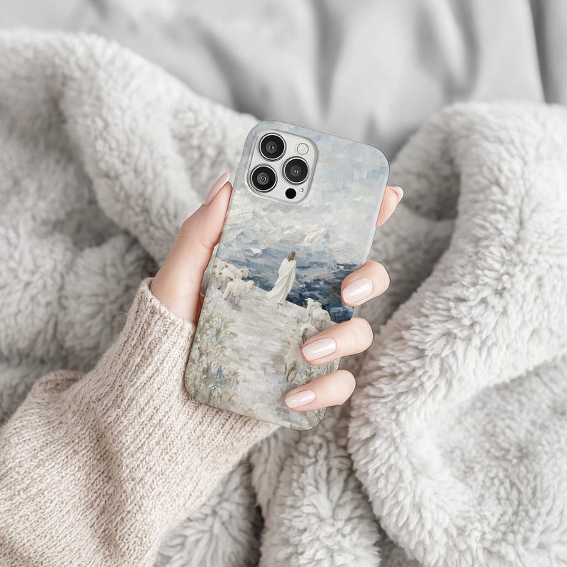 May include: A phone case featuring an impressionistic painting of a person standing on a cliff overlooking the ocean. The artwork is in shades of blue, white, and gray, with a textured, painterly effect. The case has a glossy finish and a camera cutout.