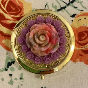 May include: A set of three ceramic mugs with a speckled, matte finish. Each mug features a different color: light blue, cream, and gray. The mugs have a simple, modern design and a comfortable handle.