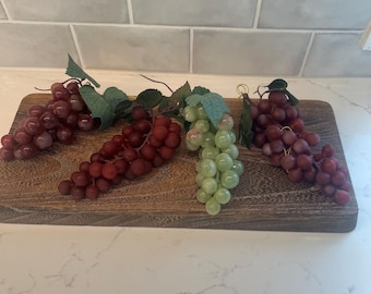 4 clusters of artificial rubber and plastic fruit grapes in red, dark red, and green colors