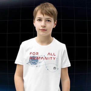 May include: White t-shirt with the text "FOR ALL HUMANITY" in red and a blue graphic of a space-themed design. The shirt is worn by a person.