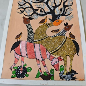 May include: A colorful Gond art painting featuring stylized animals and birds under a tree. The artwork includes a red and white striped animal, turtles, and creatures with patterned bodies and long necks. The background is a peach color.