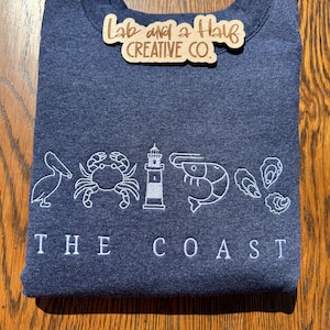 The Coast Embroidered Sweatshirt | Nautical Lighthouse Crab Shrimp Oyster Design | Coastal Living Gift