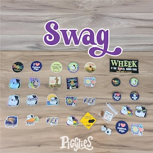May include: A collection of guinea pig-themed stickers and small items on a wooden surface. The word "Swag" is displayed in large purple letters. Various stickers feature guinea pigs, text like "I love Guinea Pigs," and other graphics.