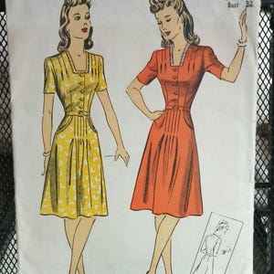 May include: Vintage sewing pattern for a dress with a fitted bodice and a full skirt. The pattern is for size 14, bust 32. The pattern is illustrated with two women wearing the dress in yellow and red.