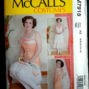May include: McCall's Costumes sewing pattern M7915. The pattern features a woman in a peach and white dress with a corset-style bodice. The pattern includes multiple views and sizes A5 (6-8-10-12-14).