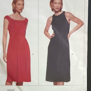May include: Vogue Patterns sewing pattern featuring two Donna Karan New York dress designs. The pattern includes a red dress with a scoop neckline and a black sleeveless dress. The Vogue logo and size information are visible.