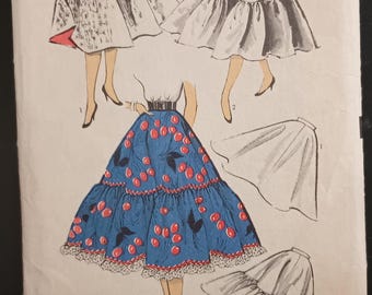 May include: Vintage Advance sewing pattern envelope. The envelope features illustrations of skirts, including a blue skirt with a cherry print. The text on the envelope reads "ADVANCE" and "6468". Waist 24.5 inches, hip 32 inches.