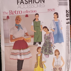 May include: McCall's Fashion Accessories pattern envelope featuring a retro collection of 1950s aprons. The cover displays illustrations of various apron styles, including a red and white skirt apron and a green floral apron.