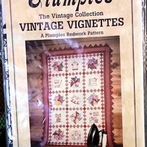 May include: A vintage quilt pattern titled "Vintage Vignettes" by Plumples Redwork. The pattern features a quilt with a red and white color scheme and a variety of small, detailed designs. The pattern is available from Plumples Redwork, located at 68 Deer Trail, Garden Valley, Idaho 83622. The phone number is (208) 462-6778.