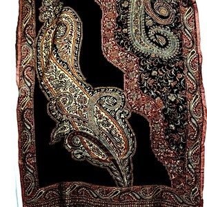May include: A black shawl with a paisley pattern in shades of brown, gold, and cream. The shawl has a fringed edge.