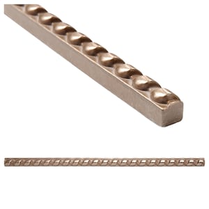 May include: A close-up of a decorative tile trim with a rope-like design. The tile is a light brown colour and has a smooth, glossy finish.