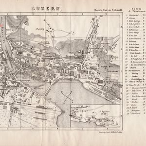 May include: A black and white vintage map of Luzern, Switzerland, featuring a detailed street grid, the Reuss River, and Lake Lucerne. The map includes a numbered index of hotels and landmarks on the right side, with grid coordinates and text labels.