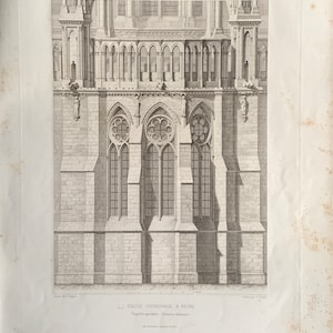 May include: A black and white engraving of Reims Cathedral in France. The image shows the chapel apse, exterior elevation. The text "Eglise Cathedrale, a Reims" is printed below the image.