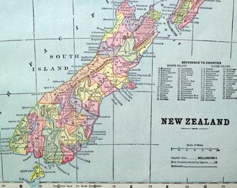May include: A vintage map of New Zealand, showing the country's two main islands, North Island and South Island. The map is color-coded to show the different counties and regions. The map also includes a scale of miles and a key to the counties.