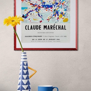 May include: A framed abstract art print with a red frame, a yellow flower in a blue and white vase, and a blue teacup on a red table. The print features the name "CLAUDE MARÉCHAL" and exhibition details.