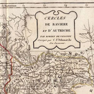 May include: A section of an antique map, displaying the text "CERCLES DE BAVIERE ET D'AUTRICHE" and geographical features. The map has a vintage appearance with faded colours and detailed linework, typical of historical cartography.