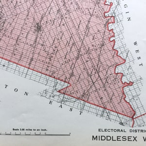 May include: A black and white map of Middlesex West, Ontario, Canada. The map shows the boundaries of the electoral district, which is outlined in red. The map also shows the names of the towns and cities within the district, including "Ambton", "East", "West", and "Ggin". The scale of the map is 3.95 miles to an inch.