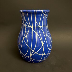 Blue ceramic vase with white lines