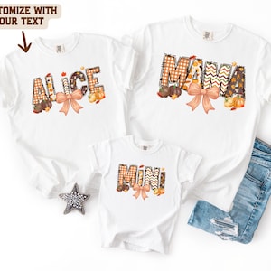 May include: Three white t-shirts featuring fall-themed graphics with the text ALICE, MAMA, and MINI. Each word is filled with orange and brown plaid and chevron patterns, accented by illustrated pumpkins, autumn leaves, and a peach-colored bow.