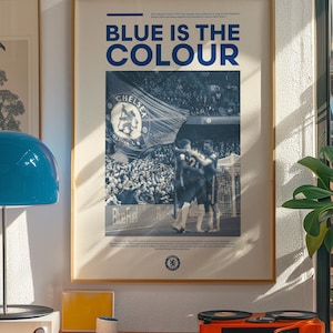 May include: A blue and white poster with the text "Blue is the Colour" and a photo of a crowd of people at a soccer game. The poster also features the Chelsea Football Club logo.