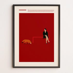 May include: A framed poster featuring a deep red background with a small orange fox on the left and a person in a black outfit sitting on a red bench on the right. The top section contains small printed text and a horizontal red line element.