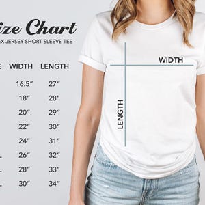 May include: A white short sleeve t-shirt size chart with text reading Size Chart, Unisex Jersey Short Sleeve Tee, and a table listing sizes XS through 4XL with corresponding width and length measurements in inches, alongside a diagram of a t-shirt.
