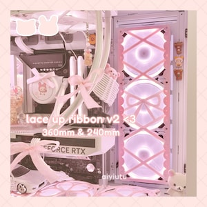 May include: Pink and white computer case with a lace-up ribbon design. The case has a clear panel on the side, revealing a pink and white fan with a lace-up ribbon design. The text "lace up ribbon v2 <3 360mm & 240mm" is visible on the case.