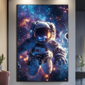 May include: An astronaut floats in space, surrounded by a vast expanse of stars and galaxies. The astronaut's spacesuit is white with a blue and orange glow, and the background is a deep blue with hints of purple and pink.