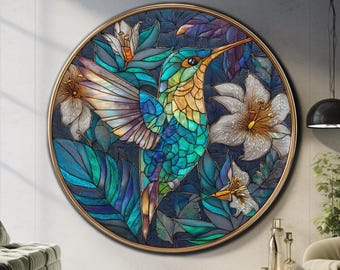 May include: A round wall art piece featuring a colorful hummingbird with outstretched wings, surrounded by flowers and leaves in shades of blue, green, and gold. The artwork is framed in a gold-colored circular frame.