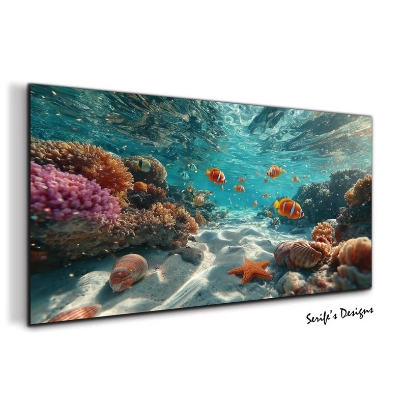 May include: A rectangular wall art print featuring an underwater coral reef scene with bright orange clownfish, a textured orange starfish, and various sea shells resting on a sandy ocean floor under clear blue water with light reflections.