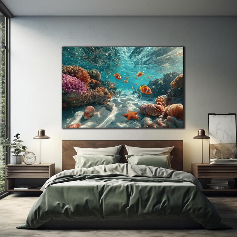 May include: A rectangular wall art print featuring an underwater scene with vibrant orange clownfish swimming near a colorful coral reef. The sandy ocean floor is visible with a bright orange starfish and various seashells resting on the seabed.