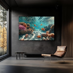 May include: A rectangular wall art print depicting an underwater coral reef scene with vibrant orange clownfish, a bright orange starfish, and textured coral formations resting on a sandy ocean floor beneath clear, sunlit turquoise water.