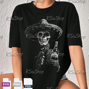 May include: Black t-shirt featuring a detailed white illustration of a skull wearing a sombrero and holding a bottle. The design includes a scarf and floral elements, creating a Day of the Dead theme.