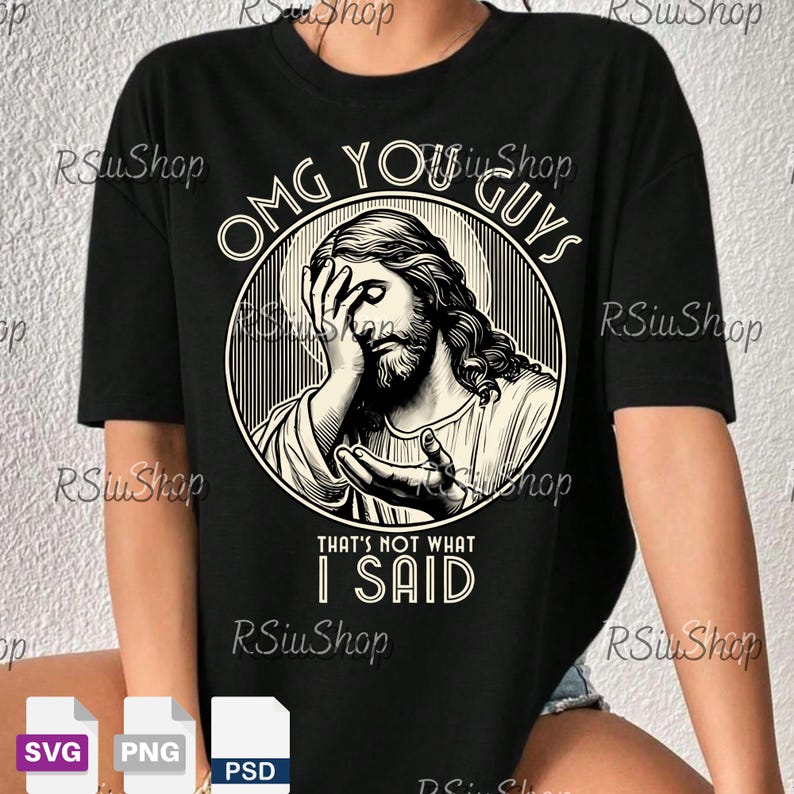 May include: Black t-shirt featuring a graphic of Jesus with the text "OMG YOU GUYS THAT'S NOT WHAT I SAID." The design is in a circular frame with a vintage aesthetic. The shirt is a casual wear item.