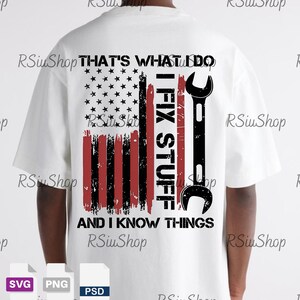 May include: White t-shirt with a distressed American flag design. The flag is red, white, and blue, with the text "THAT'S WHAT I DO, I FIX STUFF, AND I KNOW THINGS" and a black wrench graphic.