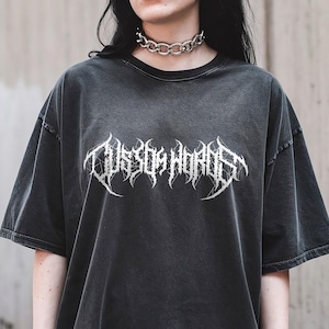 May include: Dark gray oversized t-shirt with the text "Custom Words" in a white, gothic font. The shirt has a vintage, washed appearance and short sleeves. A silver chain choker is worn around the neck.