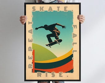 May include: A framed poster with a skateboarding theme. The artwork features a silhouette of a skateboarder mid-air, set against a backdrop of green and orange hills and a teal sky. The words "SKATE. FALL. REPEAT. RISE." are printed around the edges.