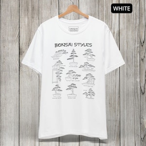 May include: A white short-sleeve t-shirt featuring a black graphic print titled Bonsai Styles. The design displays various bonsai tree shapes with labels including Wind-swept, Cascade, Formal upright, Raft, Semi-cascade, Root-over-rock, Informal upright, Double Trunk, and Group.