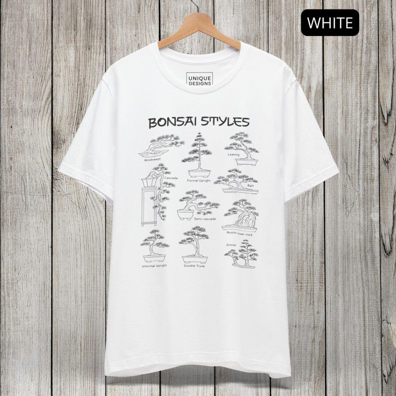 May include: A white short-sleeve t-shirt featuring a black graphic print titled Bonsai Styles. The design displays various bonsai tree shapes with labels including Wind-swept, Cascade, Formal upright, Raft, Semi-cascade, Root-over-rock, Informal upright, Double Trunk, and Group.