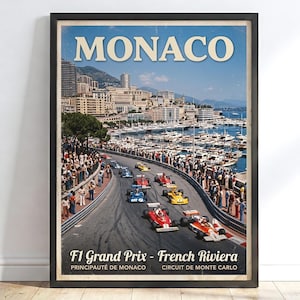 May include: A framed vintage-style poster featuring the Monaco F1 Grand Prix on the French Riviera. The image displays Formula 1 race cars on a track, a harbor filled with boats, and city buildings. Text reads MONACO, F1 Grand Prix - French Riviera.