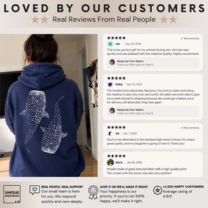 May include: A navy blue hooded sweatshirt featuring a white graphic print of two whale sharks on the back. The image includes customer reviews with five-star ratings and text stating Loved By Our Customers and Real Reviews From Real People.