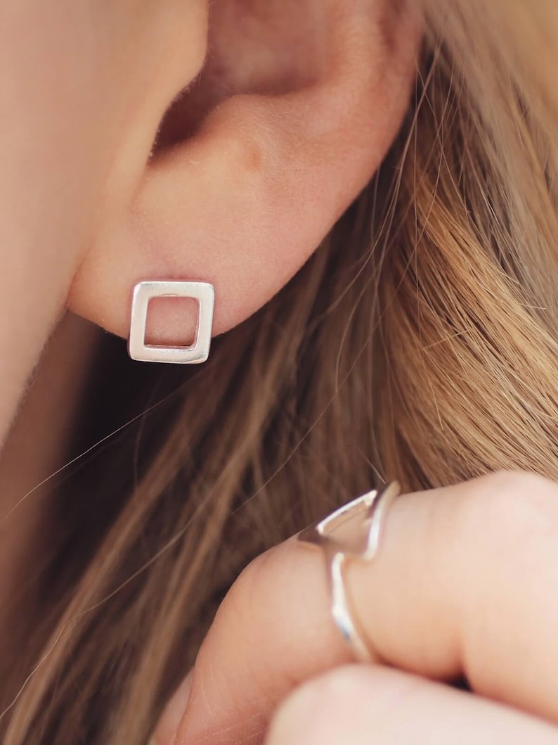 Matte silver stud earrings worn, everyday earrings