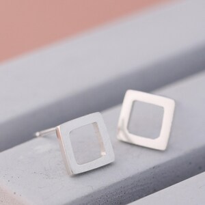 Matte square earrings on grey dish, simple earrings