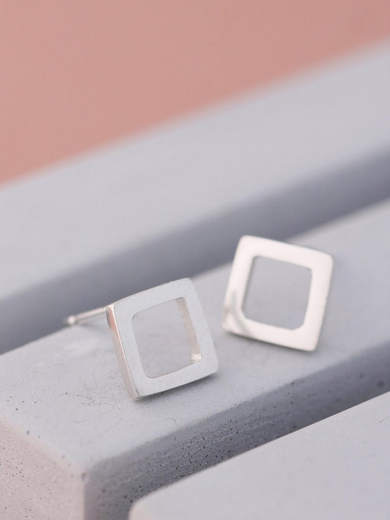 Matte square earrings on grey dish, simple earrings