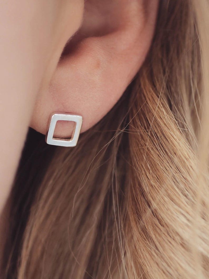 Square earrings worn in matte finish, minimal earrings