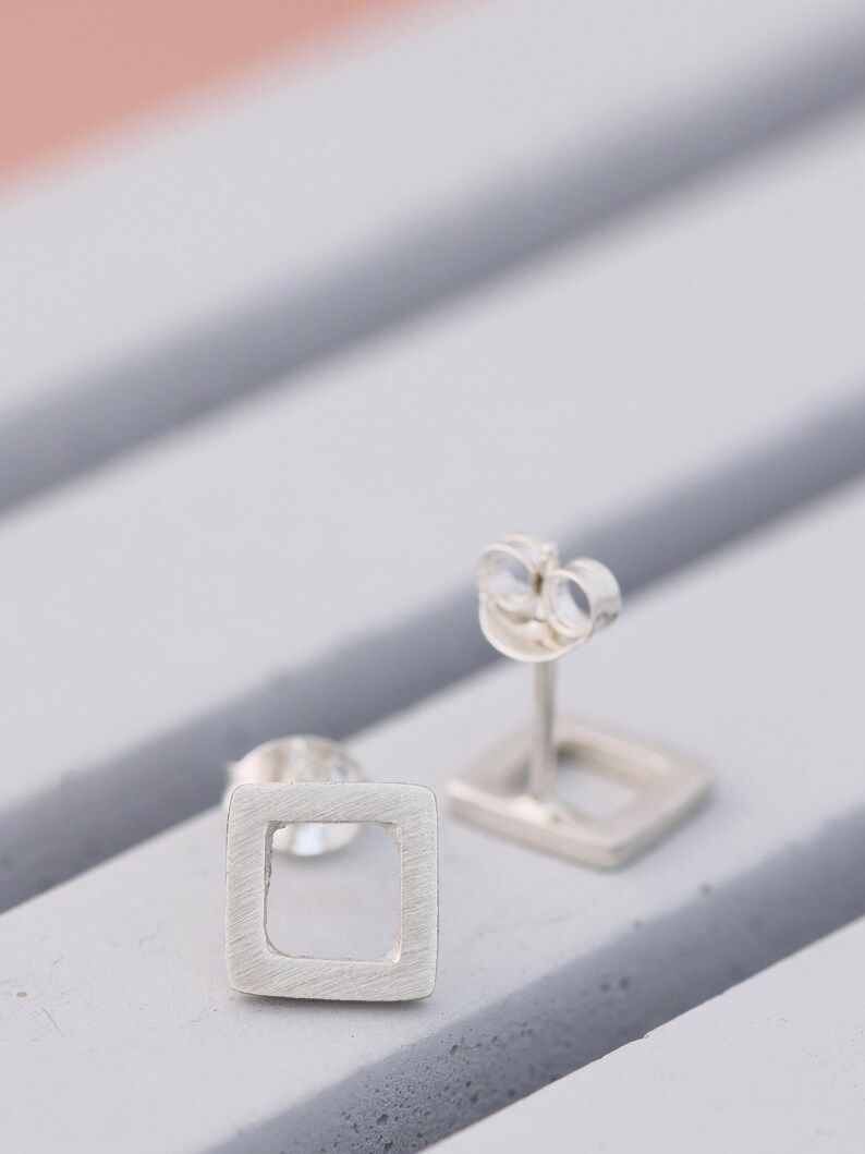 quare stud earrings in matte silver showing post and scroll backs