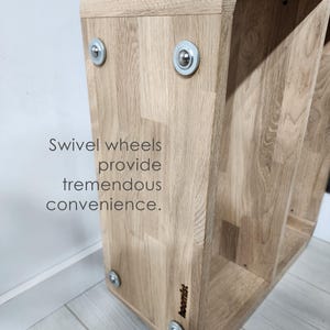 Perfect for modern living rooms, this minimalist C-form side table is handcrafted from solid oak. Features smooth wheels and a built-in magazine rack for ultimate convenience.