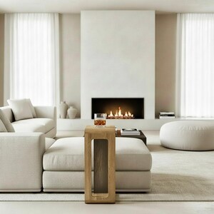 Perfect for modern living rooms, this minimalist C-form side table is handcrafted from solid oak. Features smooth wheels and a built-in magazine rack for ultimate convenience.