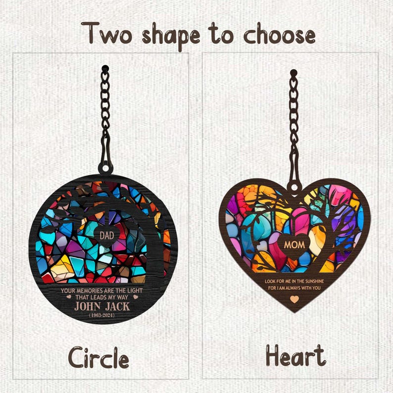 May include: Two stained glass ornaments, one in a circle shape and one in a heart shape. Both feature a tree design with colorful glass pieces. The circle ornament has the text "DAD" and "YOUR MEMORIES ARE THE LIGHT THAT LEADS MY WAY JOHN JACK (1963-2024)". The heart ornament has the text "MOM" and "LOOK FOR ME IN THE SUNSHINE FOR I AM ALWAYS WITH YOU".